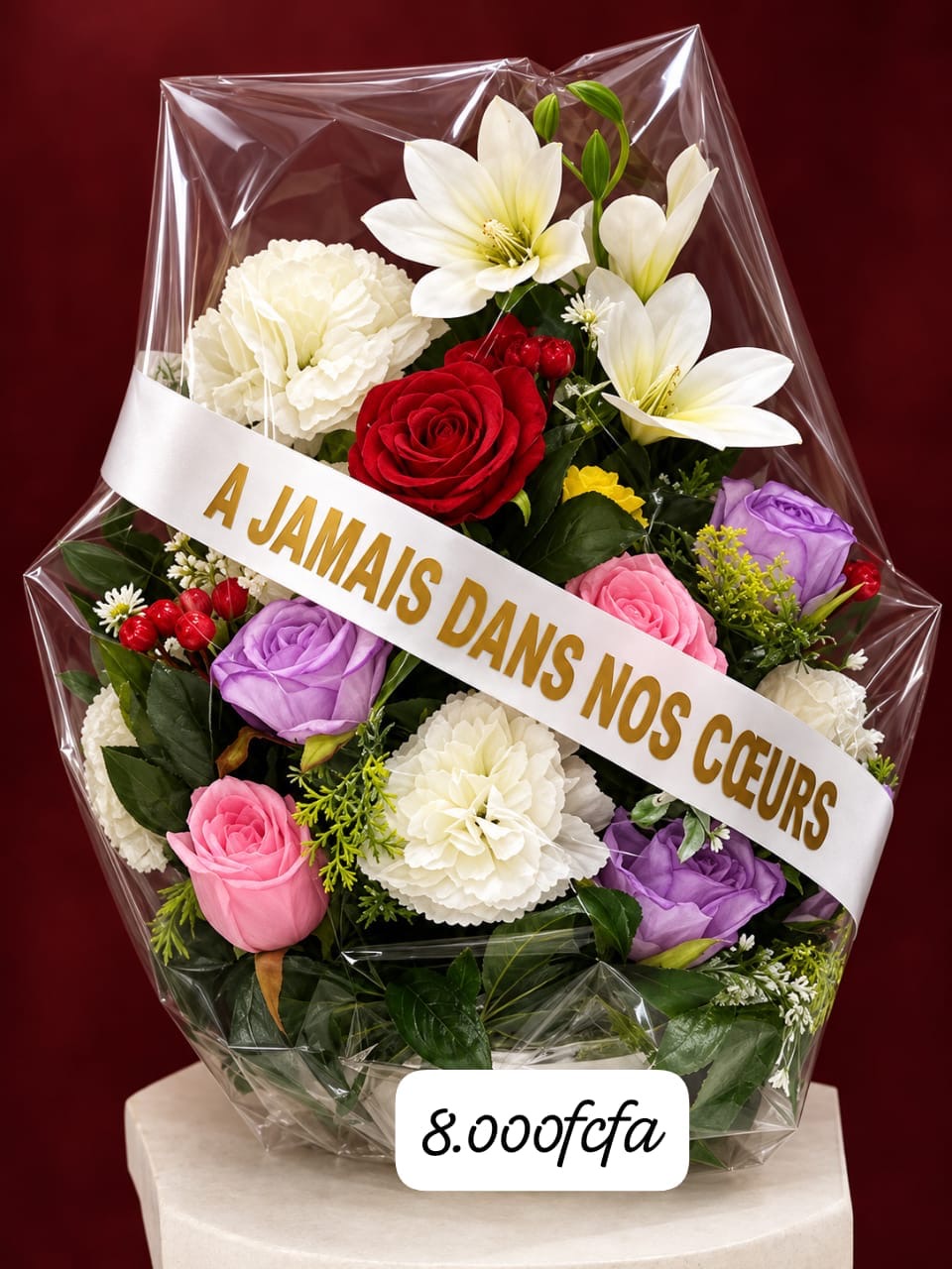 Composition d'œillets blancs, lys et roses, ruban « À jamais dans nos cœurs »